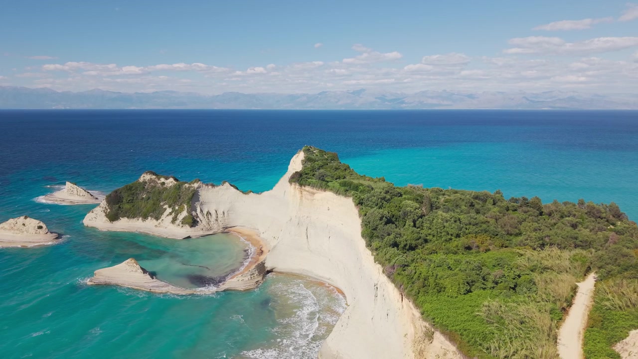 Aerial drone footage of Cape Drastis white cliffs and turquoise sea in Corfu