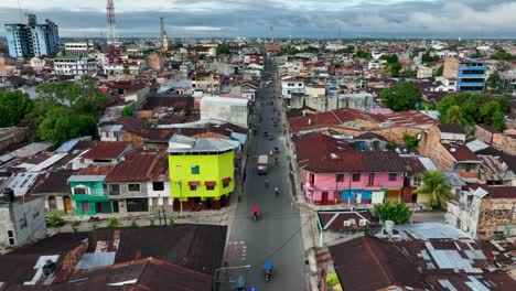 aerial drone fly view of moto taxi tuk tuk tuks and heavy traffic close to belen market in iquitos, peru, south america