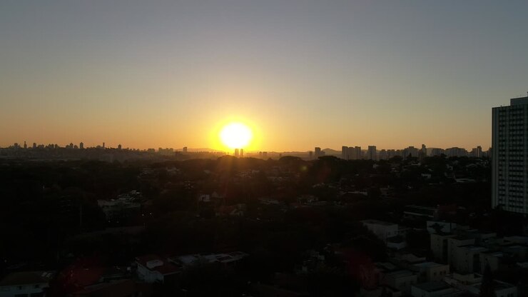 Flying towards the sunset in wooded neighborhood in São Paulo - Brazil