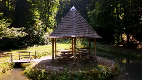 aerial parallax around small gazebo on island in pond