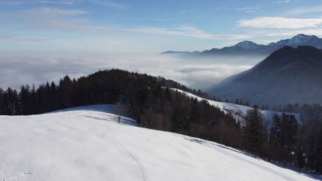 aerial of snowy mountains and sea of fog in the bavarian alps