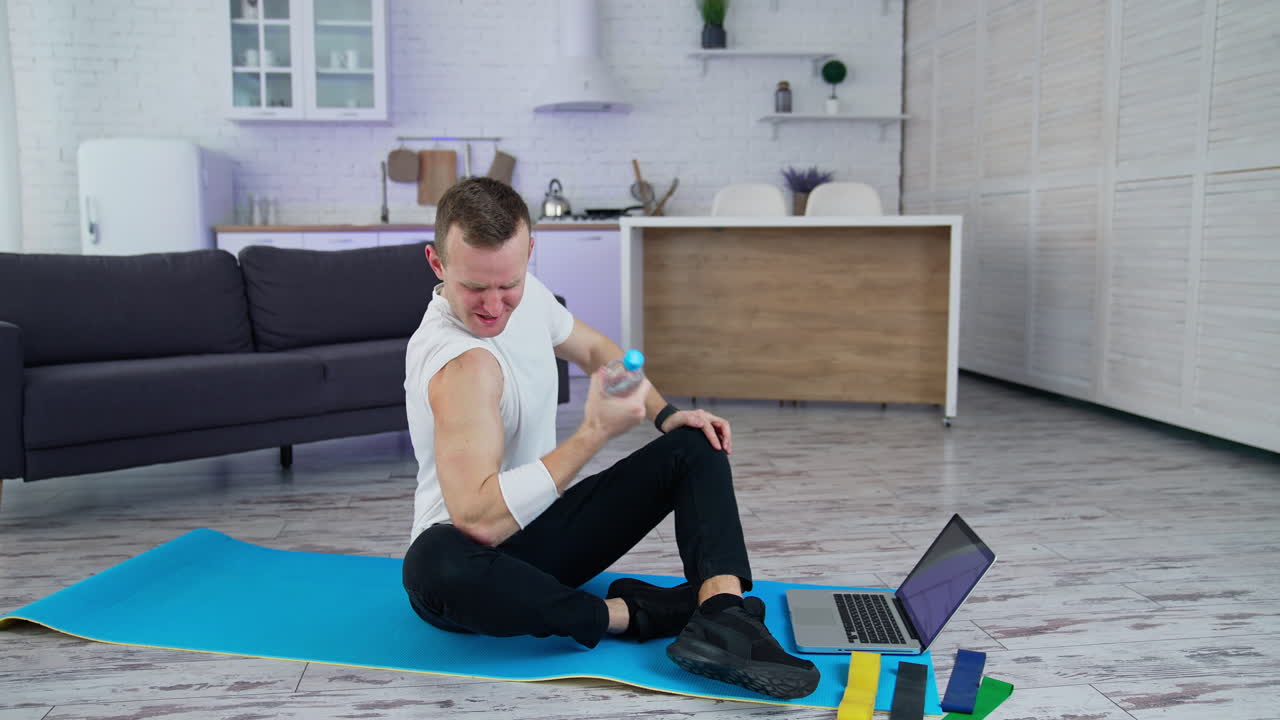 Sport exercises at home. A man uses household items for sport exercises