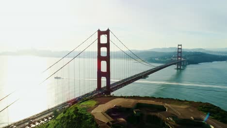drone flies right over golden gate, sunny day, tourist boat sails, san francisco
