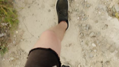 pov of man legs walking on dusty landscape of tenerife island