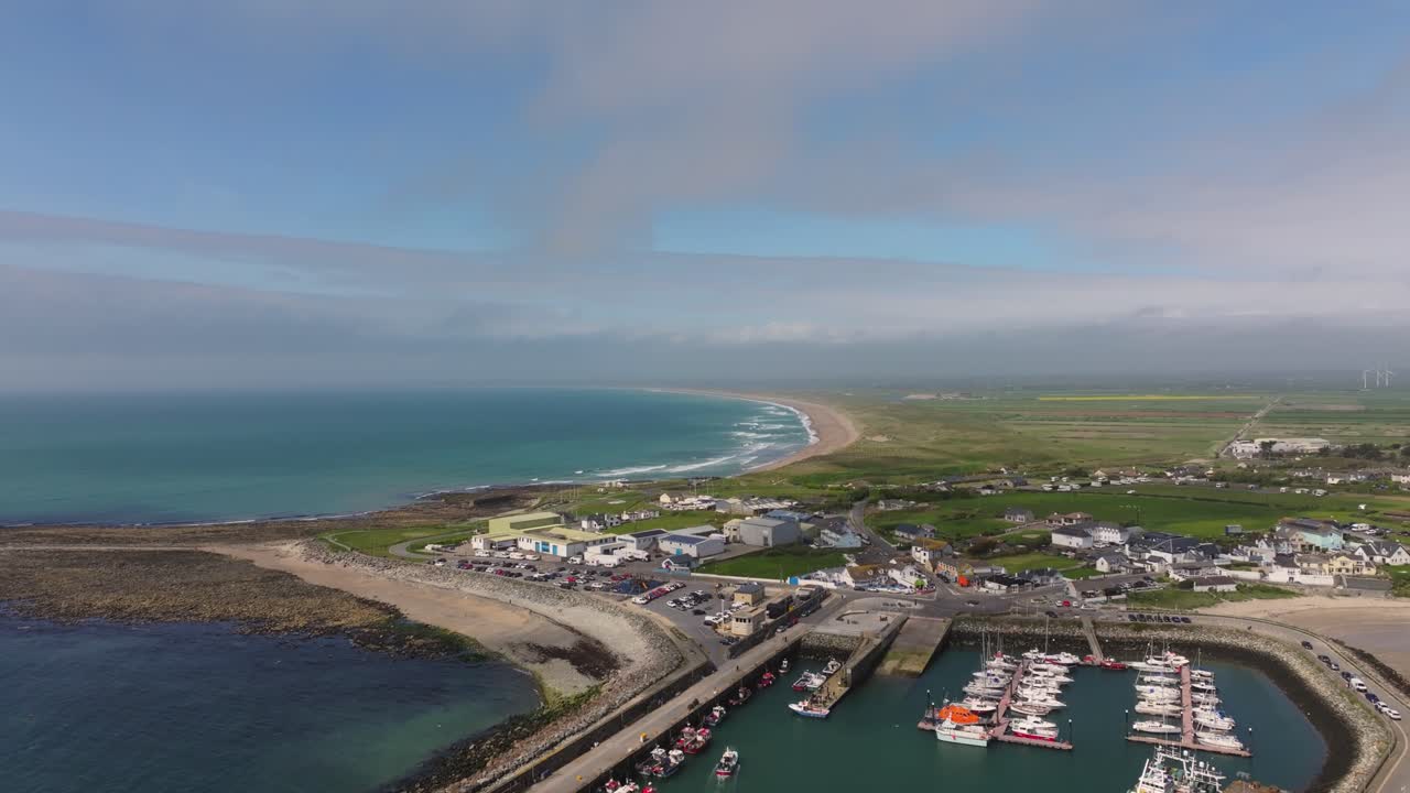4K cinematic drone footage capturing Kilmore Quay, on a bright day, showcasing the picturesque harbour, and colourful fishing boats Co.Wexford - Ireland_014