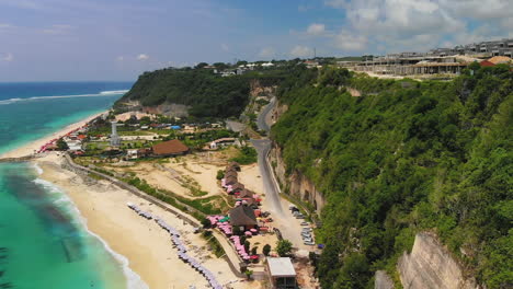 Drone-Volando-Por-Encima-De-La-Carretera-Que-Conduce-A-La-Playa-De-Pandawa-En-Bali,-Indonesia