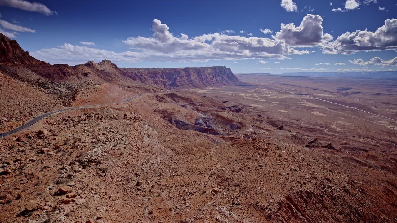 Sweeping drone shot over a maze of rock spires and vividly colored desert textures.