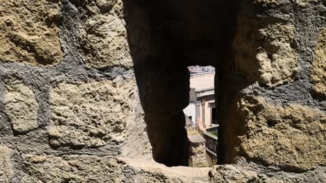 stone window revealing a cityscape in naples