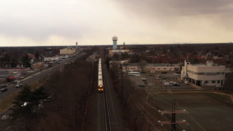 an aerial view over railroad tracks on a cloudy day