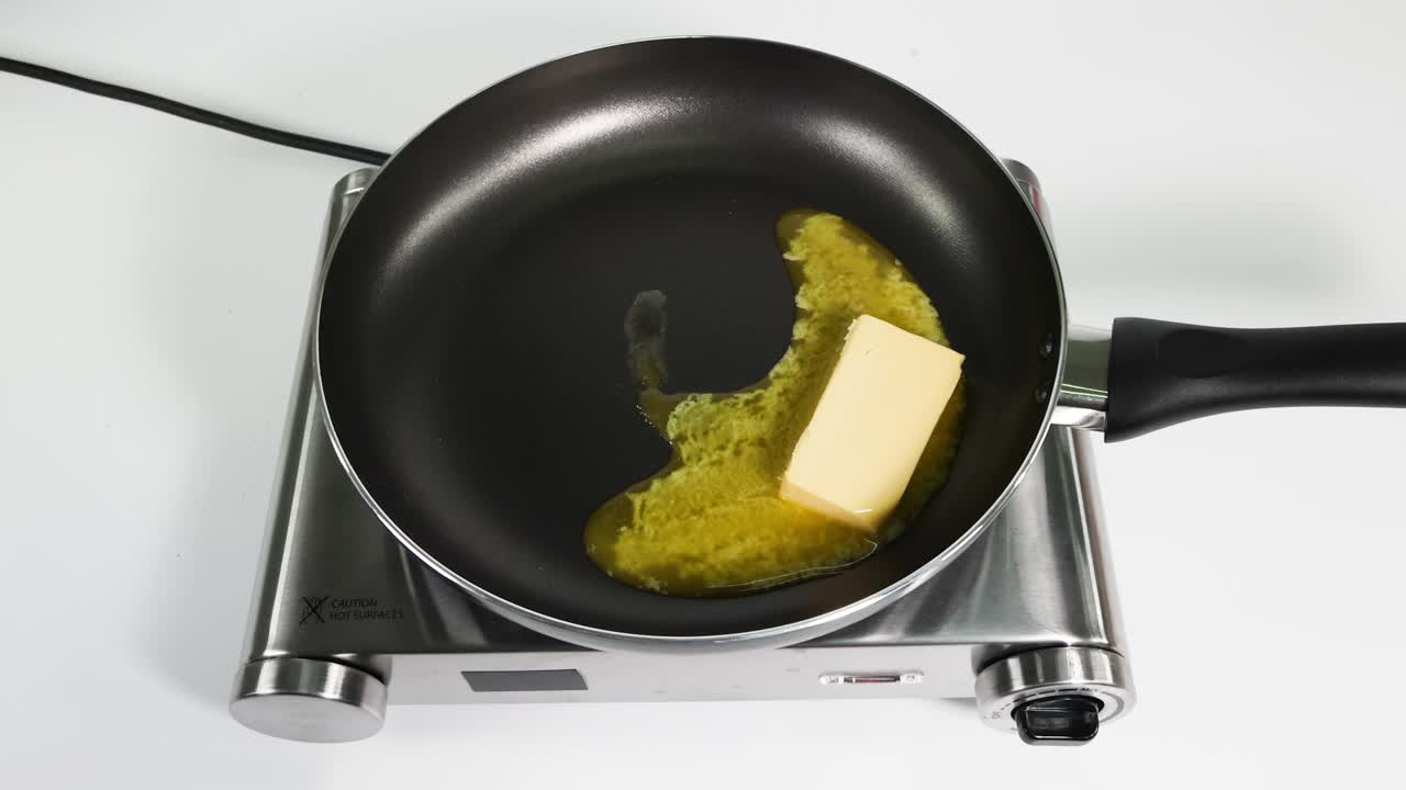 Butter melting and bubbling in a frying pan