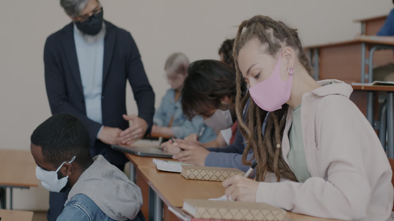 Students in a Classroom Taking Notes During a Lecture
