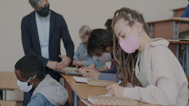Students in a Classroom Taking Notes During a Lecture