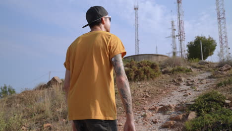 young diabetic fit men hiking with blood sugar sensor on his arm