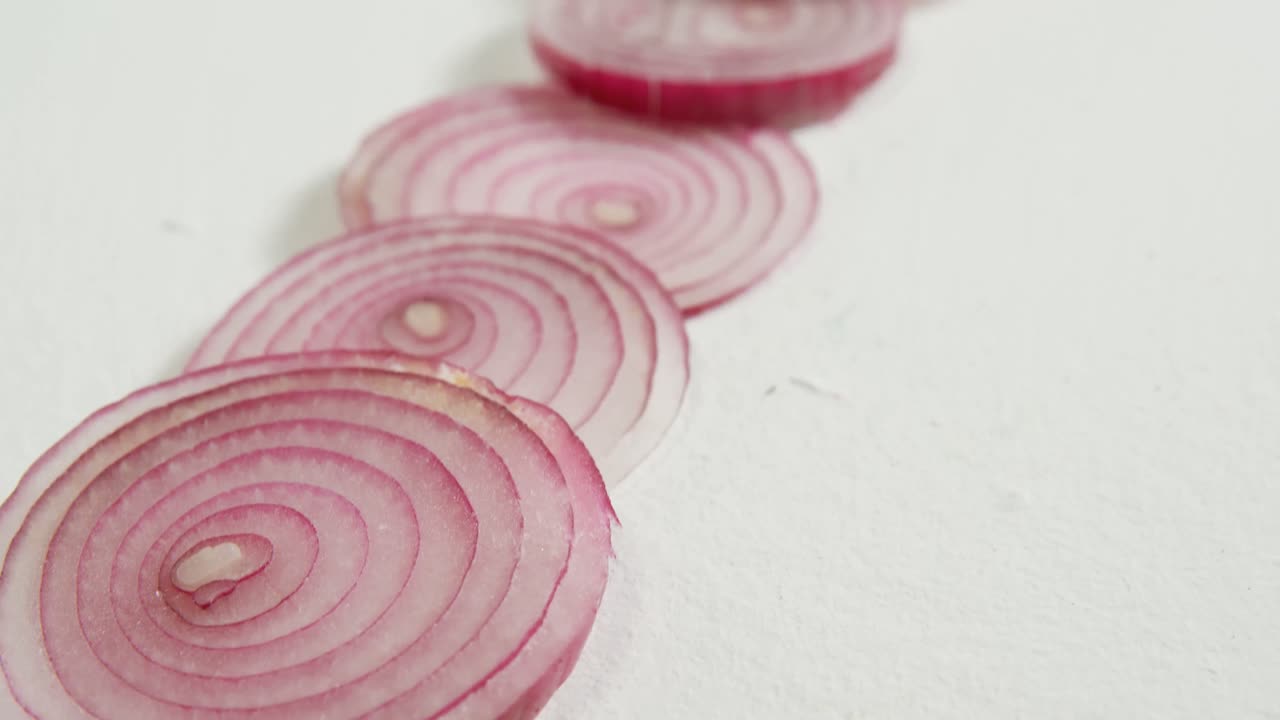 Slices of red onion placed on white background 4K 4k