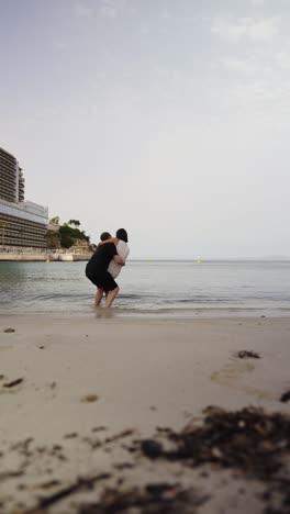 Vertical-shot-of-happy-couple-enjoy-life-and-vacation-at-beach-resort,-Mallorca