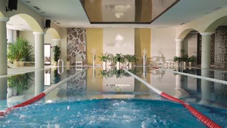 woman in swimsuit by indoor pool