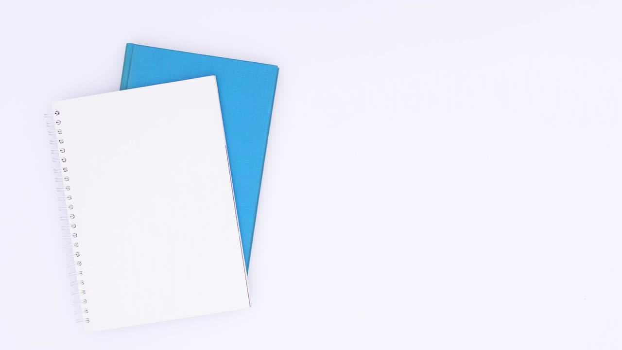 Closure on blue pencil open and moving on white background with blue business stationery. Stop motion