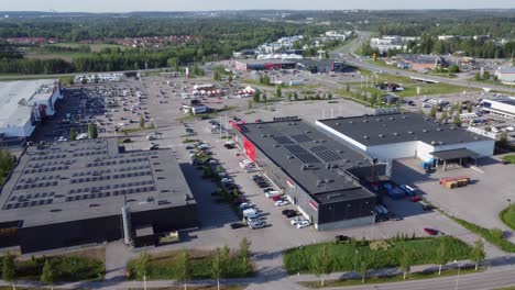 aerial rotates to reveal retail shopping plaza in lahti, finland