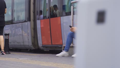 young man sitting on the street in the city.