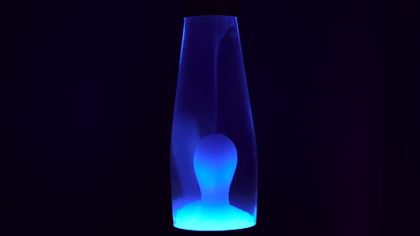 blue lava lamp with a dark background