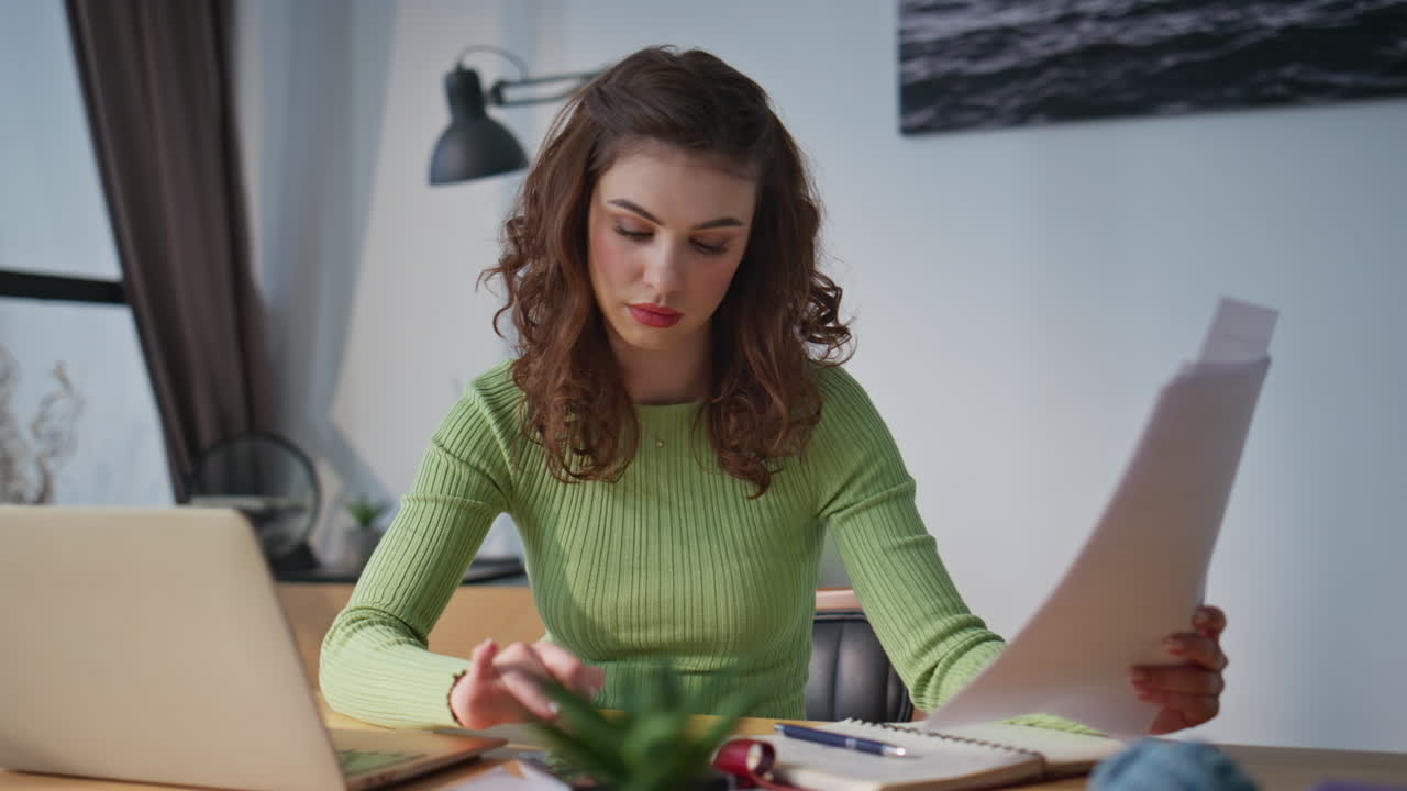 Focused woman reading papers in office closeup. Worried girl analyzing documents