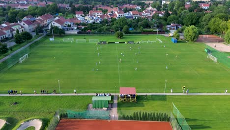 a side view of the camera showing the full extent of the pitch and the football players playing