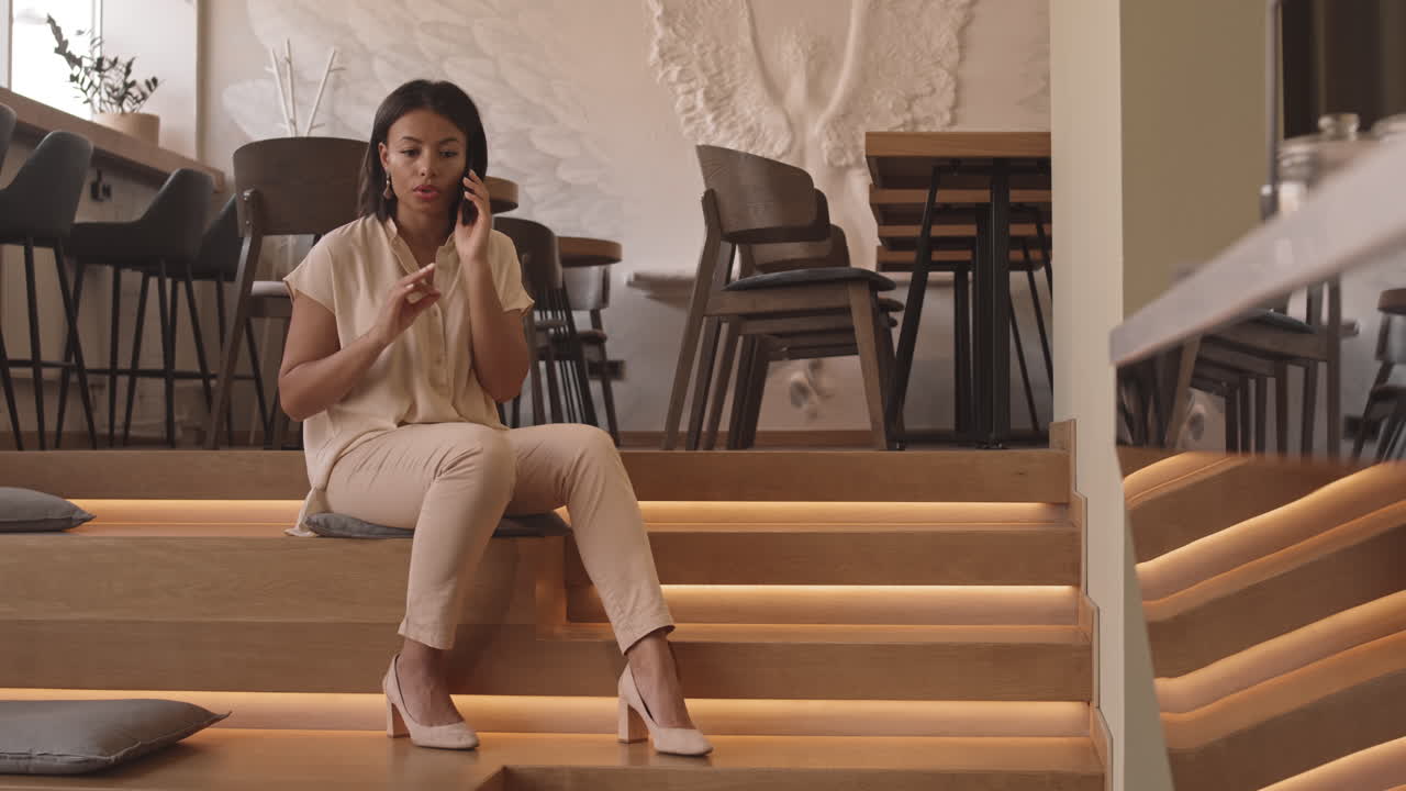 Woman Talking on Phone on Stairs