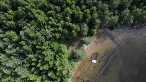 Overhead-zoom-down-onto-a-camp-site-along-the-Nisser-lake,-Treungen,-Telemark,-Norway