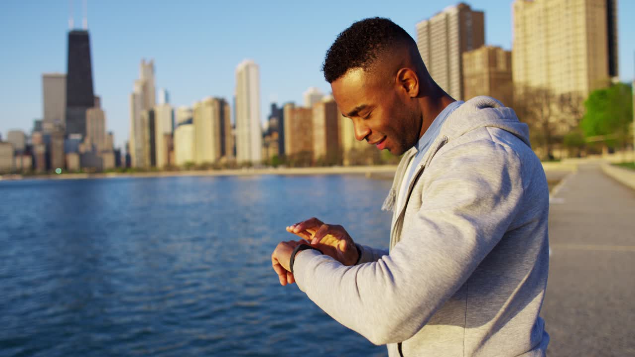 Athletic African American male resting wearing smart watch