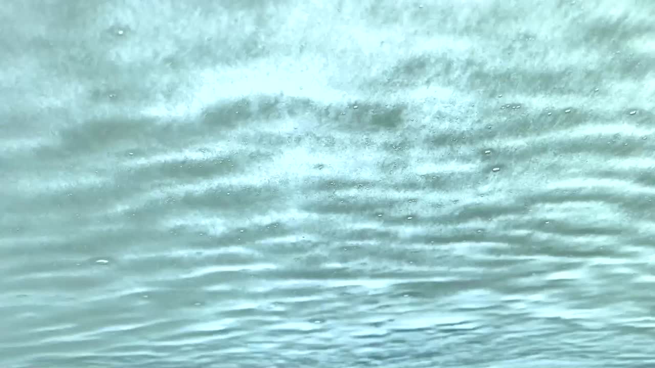 Car windshield being sprayed with soap at an automatic car wash.