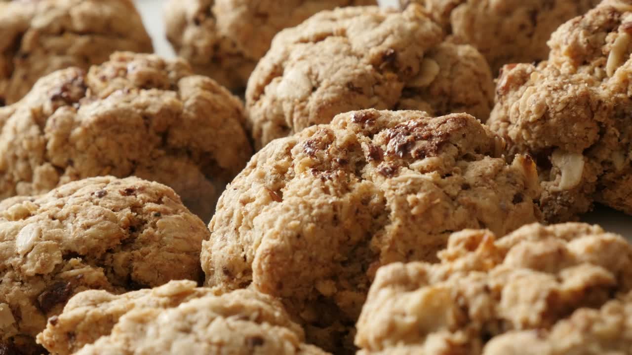 Tasty chocolate chip cookies pile close-up 4K 2160p 30fps UHD panning footage - Shallow DOF oatmeal biscuits served on plate slow pan 3840X2160 UltraHD video