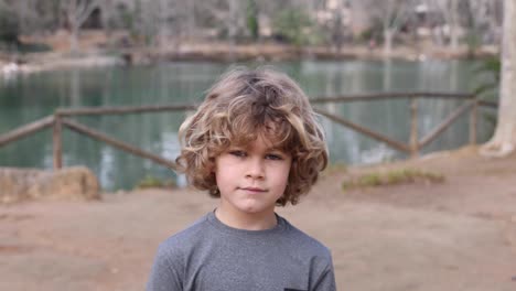 boy in hoodie with wavy hair in daytime