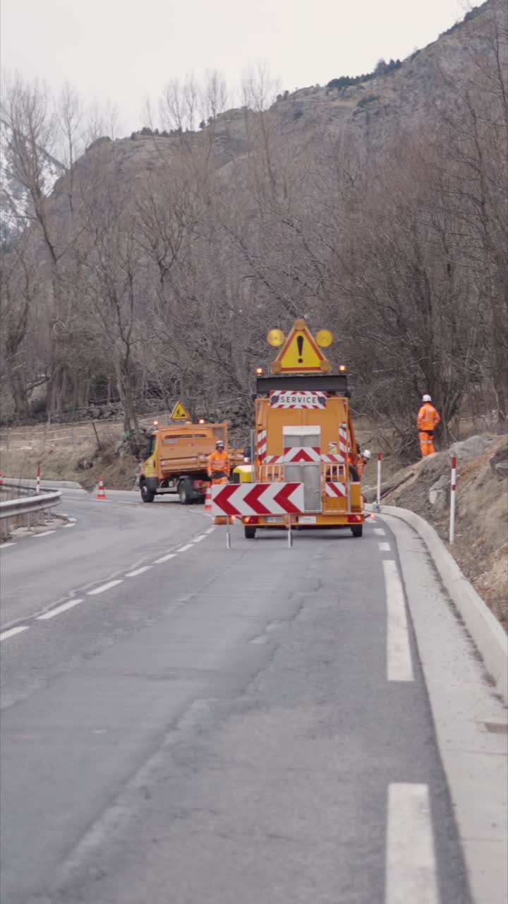 Road work with warning signs and workers present