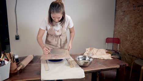 woman working with pottery on a wheel