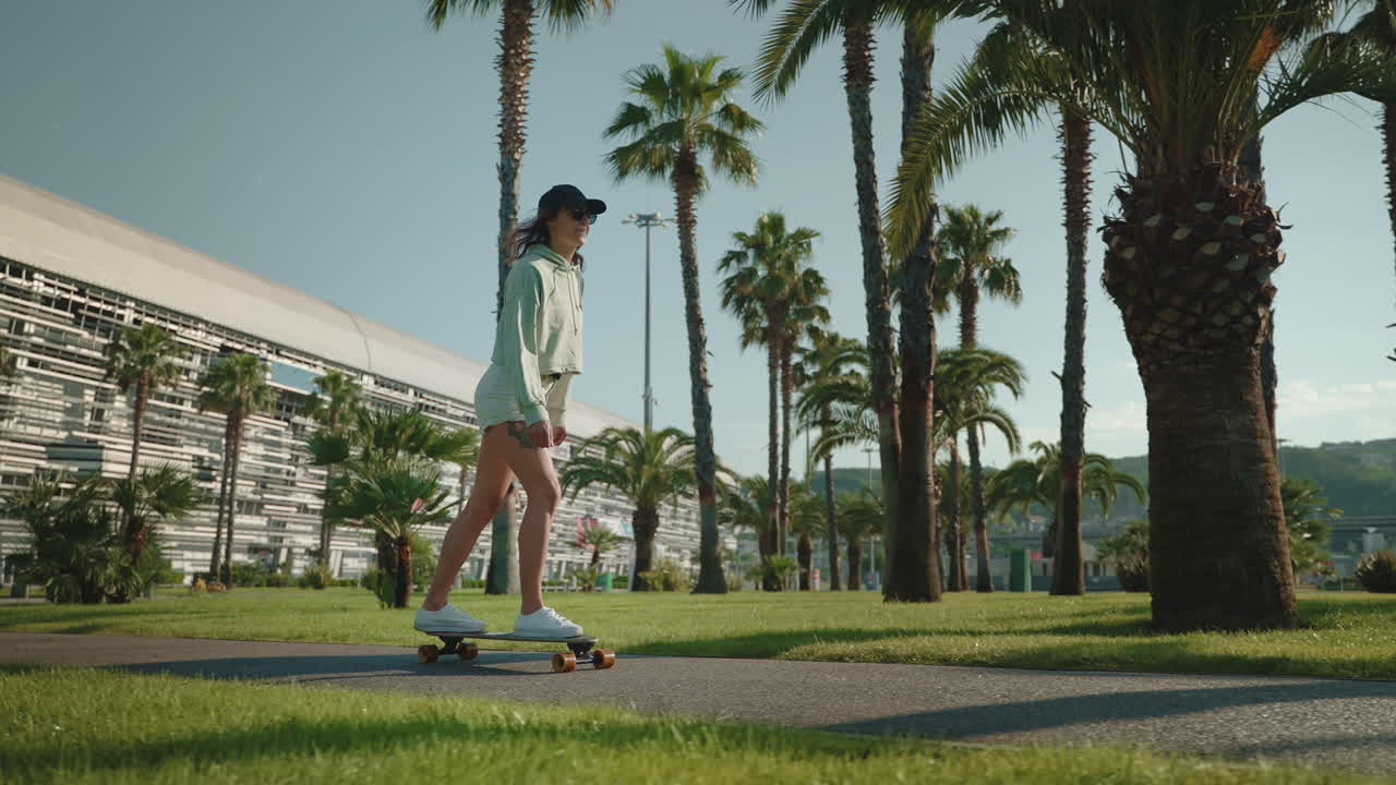 Woman Skateboarding in a Palm Tree Park