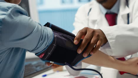 medical expert taking the pulse and blood pressure with a blood pressure monitor