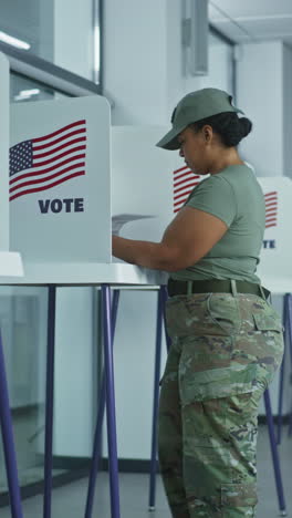 asian woman comes to voting booths in polling station office. national election day in united states. political races of us presidential candidates. concept of civic duty and patriotism. dolly shot.