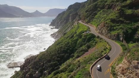 Eine-Luftaufnahme-Zeigt,-Wie-Autos-Entlang-Des-Chapman&#39;s-Peak-In-Südafrika-Am-Meer-Entlang-Fahren-1