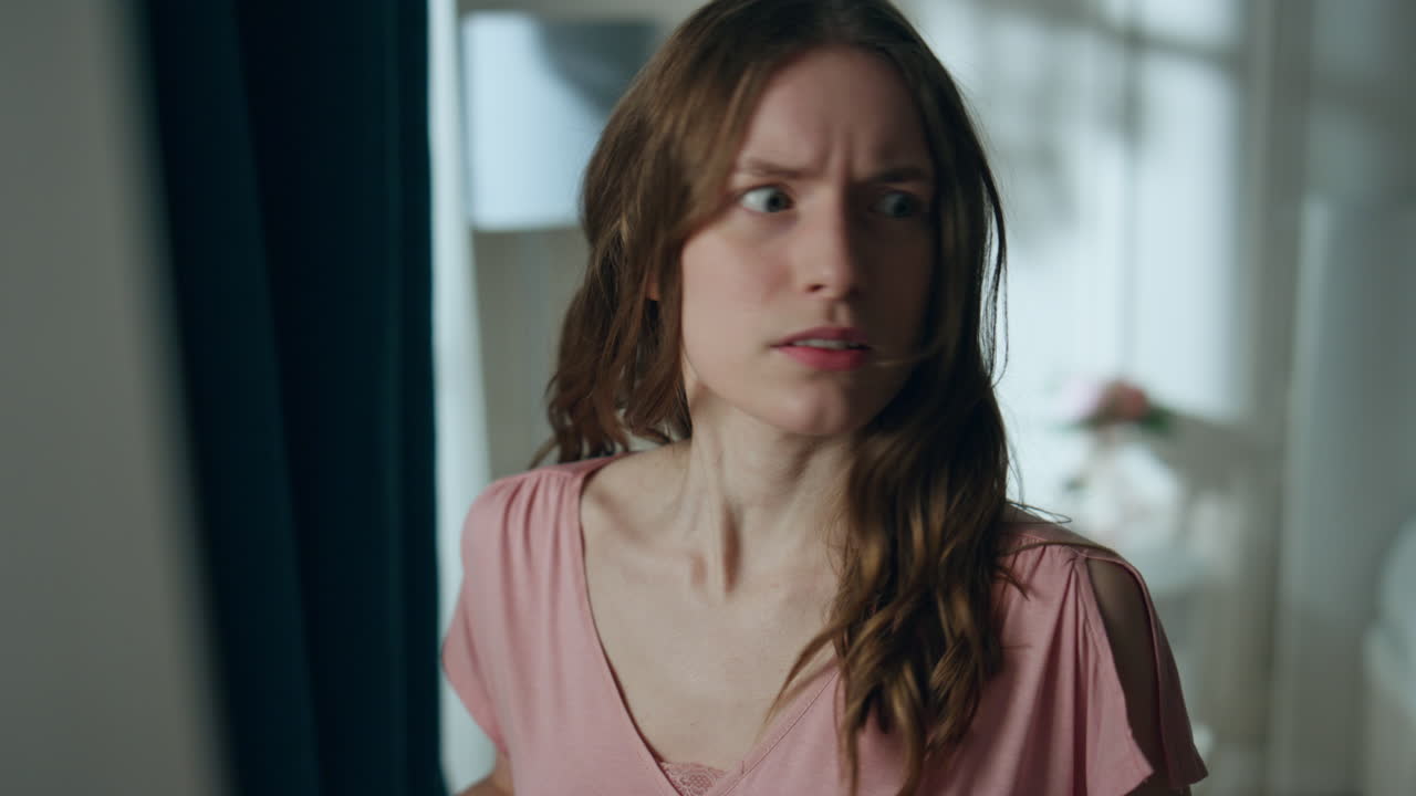 Annoyed girl talking cell at night home closeup. Furious woman hang up ending