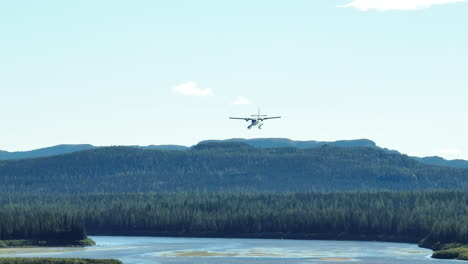 stunning wide angle view of a seaplane coming in to land near a large river in labrador, canada