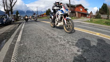 group of motorcyclists riding in the village of hornopiren. chilean patagonia