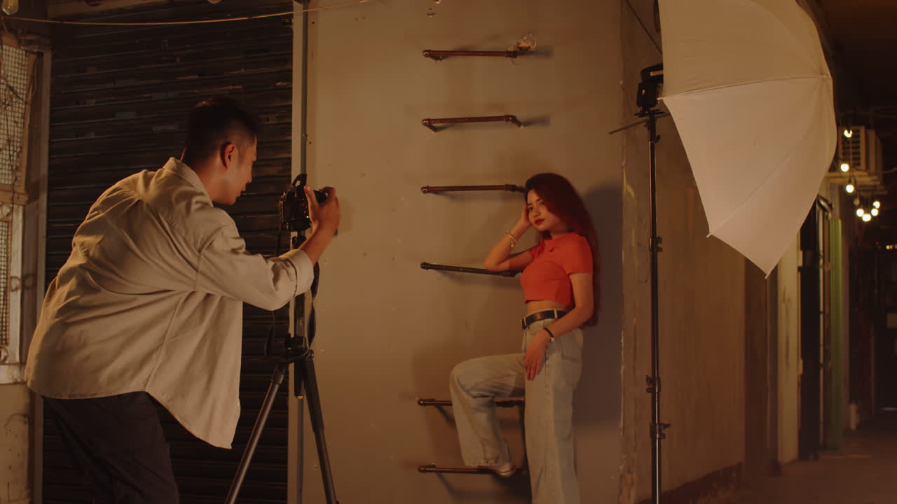 Man Photographing Female Model Inside Abandoned Building