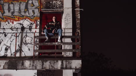 person on balcony at night