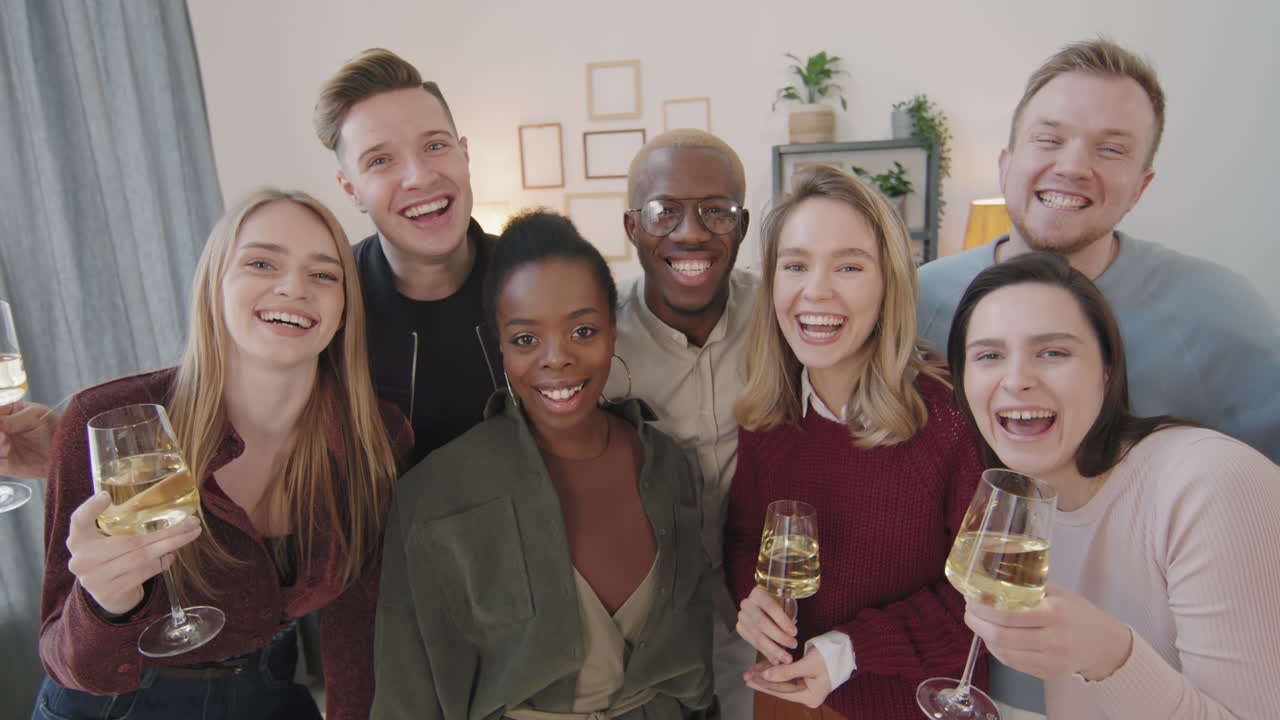Group of Happy Friends Laughing and Posing at House Party