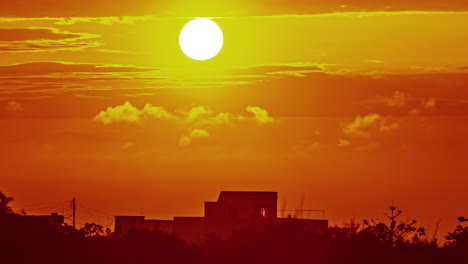 sun rising in a sunrise above the clouds and a red sky