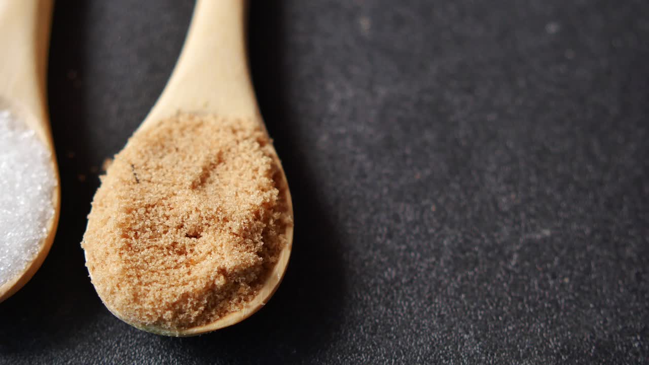 White and Brown Sugar in Wooden Spoons