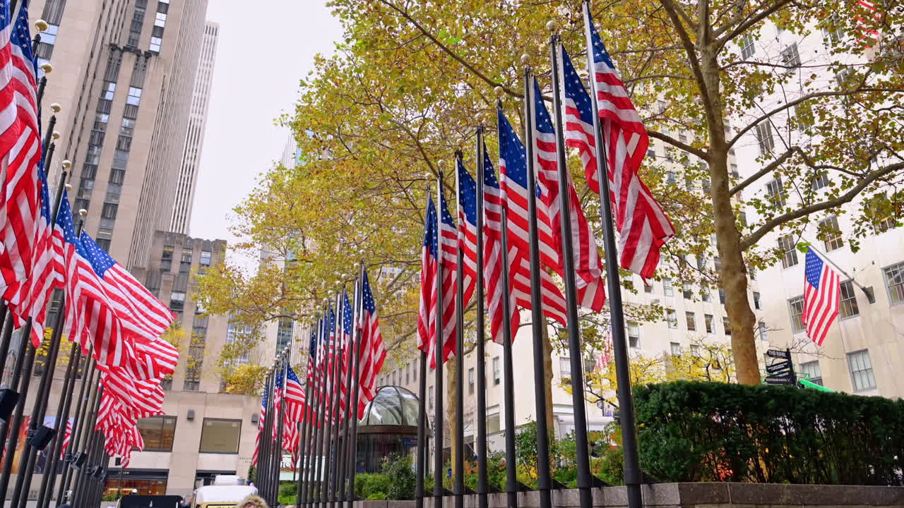 New York, USA, 12 December 2025: American flags at Rockefeller Center. Rows of American flags line Rockefeller Center plaza in autumn
