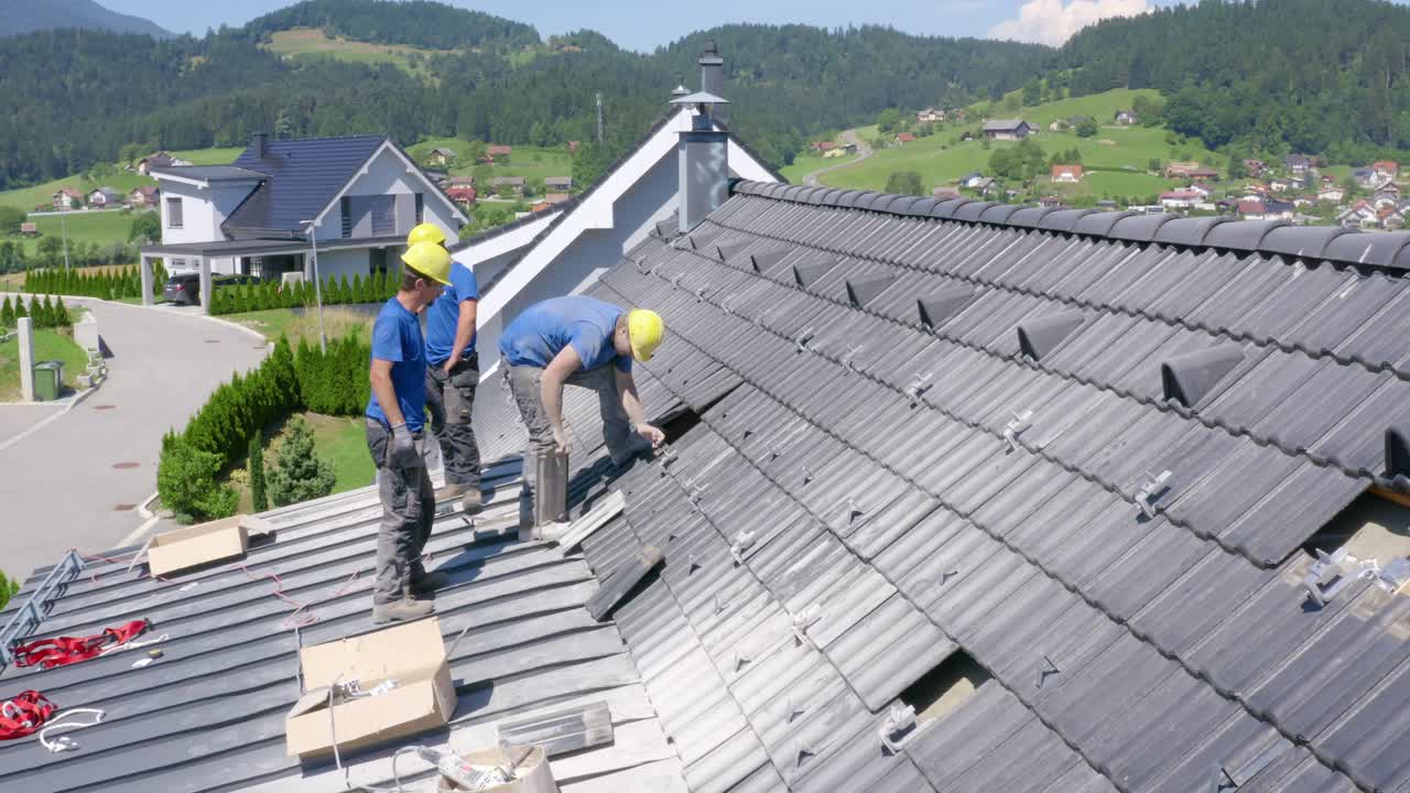 Men at work, preparing the roof of a house for installation of solar panels. Concept of professionalism,Job,solar power,renewable energy Side view