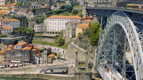 central porto, metro on luís i bridge with crowds in background, portugal 4k slowmo cinematic aerial summer mediterranean city river bank