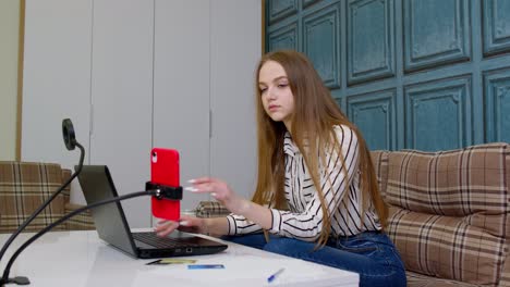 woman working on her laptop and recording a video call at home